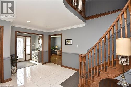 Two-story foyer featuring wood staircase with white balusters, tile flooring, recessed lighting, and crown molding - 36 Tommar Place, Hamilton, ON - Indoor Photo Showing Other Room
