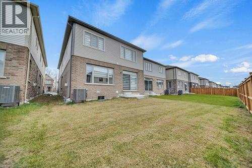 Back of house with a fenced backyard, brick siding, and a residential view - 285 Broadacre Drive, Kitchener, ON - Outdoor