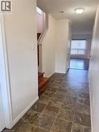 Foyer featuring square tile flooring and a neutral color palette - 