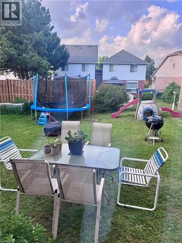 Expansive fenced yard featuring a manicured lawn and mature trees - 452 Beaumont Crescent, Kitchener, ON - Outdoor With Deck Patio Veranda