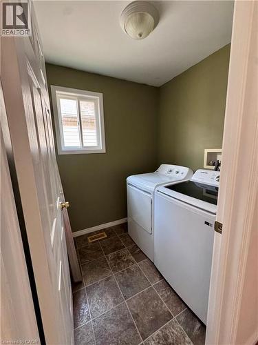Dedicated laundry area featuring a window, tile flooring, and overhead lighting - 452 Beaumont Crescent, Kitchener, ON - Indoor Photo Showing Laundry Room
