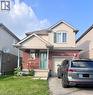 Two-story residence featuring a brick and siding facade, covered front porch, an attached single-car garage, and a concrete driveway - 452 Beaumont Crescent, Kitchener, ON  - Outdoor 