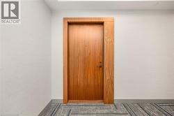 Warm wood-finish entry door with a contemporary black handle set - 