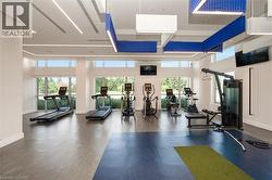 Fitness center featuring high ceilings, modern linear lighting, expansive windows, multiple cardio machines, and strength training equipment - 