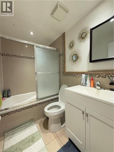 Bathroom featuring a white vanity with integrated sink, chrome faucet, and storage cabinetry - 181 Thaler Avenue, Kitchener, ON 