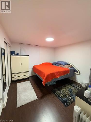 Room featuring dark wood-finish flooring, white walls, and a recessed ceiling light fixture - 181 Thaler Avenue, Kitchener, ON 
