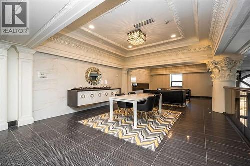 Recessed ceiling with decorative molding, dark tile flooring, and a floating console cabinet - 112 King Street E Unit# 907, Hamilton, ON 