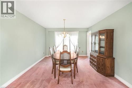 Spacious room featuring light green walls, white baseboards, and a pink carpet - 381 Kerman Avenue, Grimsby, ON - Indoor Photo Showing Dining Room
