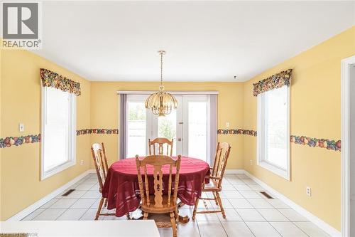 Dining area featuring white ceramic tile flooring and light yellow walls - 381 Kerman Avenue, Grimsby, ON - Indoor Photo Showing Dining Room