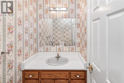 Bathroom featuring a wood vanity with a white countertop and an oval sink - 381 Kerman Avenue, Grimsby, ON - Indoor Photo Showing Bathroom