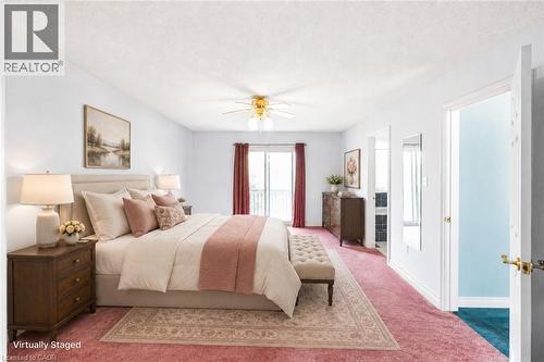 Spacious room featuring carpeting, a ceiling fan with light fixture, and a sliding glass door leading to an exterior balcony - 381 Kerman Avenue, Grimsby, ON - Indoor Photo Showing Bedroom