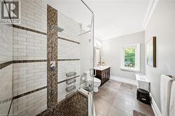 Glass-enclosed shower featuring subway tile with mosaic accents and a rainfall showerhead - 