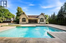 Rectangular swimming pool featuring integrated steps and ample surrounding stone paving - 
