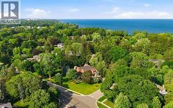 Expansive property set amidst mature trees with a prominent lake visible in the background - 