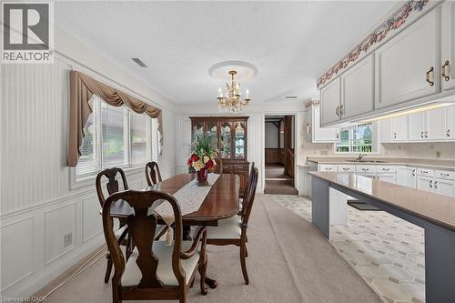 Dining area featuring white wainscoting and vertical paneling - 114 E Second Road E, Stoney Creek, ON 