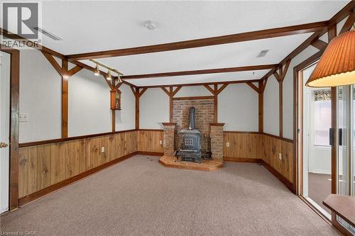Interior room featuring a brick wood-burning stove with a raised hearth - 114 E Second Road E, Stoney Creek, ON 