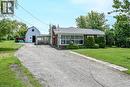 Brick exterior residence with an attached carport and a white gable barn - 114 E Second Road E, Stoney Creek, ON 