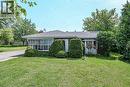 Brick exterior with a gabled roofline, a bay window, and a sunroom with multiple pane windows - 114 E Second Road E, Stoney Creek, ON 