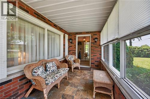 Enclosed porch featuring brick walls and flagstone flooring - 114 E Second Road E, Stoney Creek, ON 