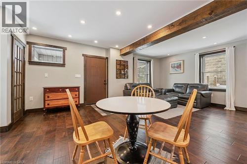 Open-concept living area with dark wood-finish flooring, exposed ceiling beams, recessed lighting, and dark wood trim - 838 Moore Street, Cambridge, ON - Indoor Photo Showing Dining Room