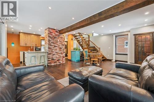 Open-concept living space featuring wood-finish flooring, exposed ceiling beams, and recessed lighting - 838 Moore Street, Cambridge, ON - Indoor Photo Showing Living Room