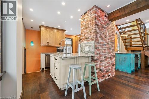 Kitchen island with a sink and a high-arc faucet, complemented by light-toned cabinetry and recessed lighting - 838 Moore Street, Cambridge, ON - Indoor Photo Showing Kitchen With Upgraded Kitchen