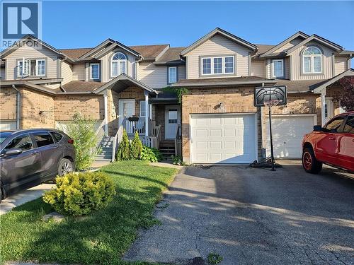 View of property with a garage, asphalt driveway, and roof with shingles - 316 Activa Avenue, Kitchener, ON 