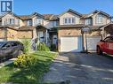 View of property with a garage, asphalt driveway, and roof with shingles - 316 Activa Avenue, Kitchener, ON 