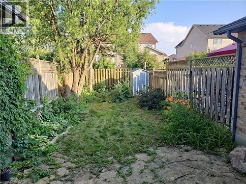 Fenced backyard with a storage unit - 316 Activa Avenue, Kitchener, ON 