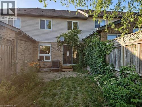 Rear view of property with entry steps and brick siding - 316 Activa Avenue, Kitchener, ON 