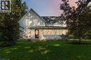 Traditional two-story residence with a covered front porch featuring white columns and latticework - 1629 Gregory Road, St. Catharines, ON 