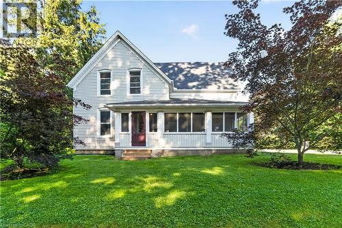 Light-colored siding exterior featuring a gable roofline and a covered porch - 1629 Gregory Road, St. Catharines, ON 