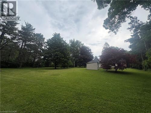 Expansive green lawn with mature trees and a detached structure - 1629 Gregory Road, St. Catharines, ON 