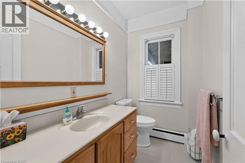 Vanity featuring a light wood-finish cabinet with multiple drawers, a white countertop, and an integrated sink - 1629 Gregory Road, St. Catharines, ON 