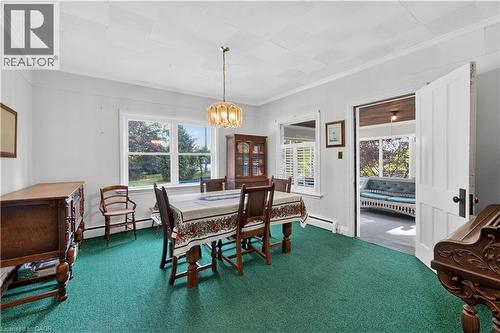 Dining area featuring a prominent window, crown molding, and a chandelier-style light fixture - 1629 Gregory Road, St. Catharines, ON 
