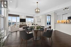 Expansive waterfront setting featuring a natural beach, clear blue water, and a paved pathway - 