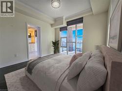 Floor-to-ceiling windows with roller shades, dark wood-finish flooring, crown molding, and a recessed ceiling feature - 