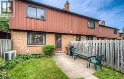 Private rear patio with concrete pavers and wood fencing - 