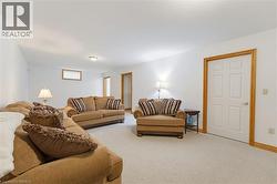 Spacious room featuring light-toned carpeting and white walls - 