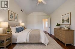 Bedroom featuring a vaulted ceiling with a ceiling fan - 