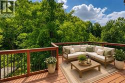 Expansive wooden deck with a durable railing system featuring wooden top rails and black metal balusters - 