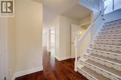 Grand staircase featuring patterned risers and white balusters - 