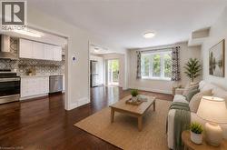 Open-concept living space with dark wood-finish flooring - 