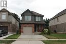 Two-story residence featuring a brick and siding facade, an attached garage, and a concrete driveway - 27 Stillwater Street, Kitchener, ON 