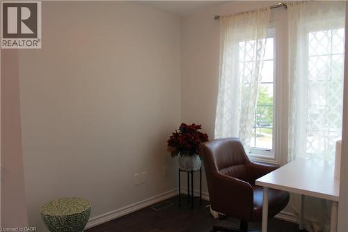 Interior space with light-toned wall paint and dark wood-finish flooring - 27 Stillwater Street, Kitchener, ON 