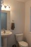 Pedestal sink with chrome faucet, wall-mounted mirror, and vanity lighting - 27 Stillwater Street, Kitchener, ON 
