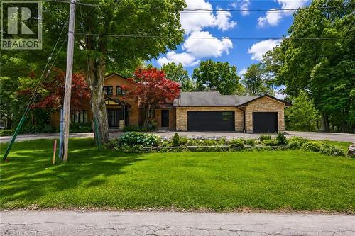 Stone facade residence with a two-car garage featuring black doors - 355 Edgehill Drive, Kitchener, ON 