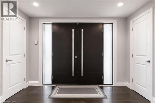 Double entry doors with vertical pull handles, flanked by frosted glass sidelights - 355 Edgehill Drive, Kitchener, ON 