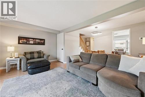 Spacious living area featuring light wood-finish flooring, light gray wall paint, and a modern ceiling light fixture - 315 Mayview Crescent Unit# B, Waterloo, ON 