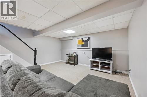 Finished recreational space featuring neutral wall tones, drop-panel ceiling, and light-toned carpet - 315 Mayview Crescent Unit# B, Waterloo, ON 